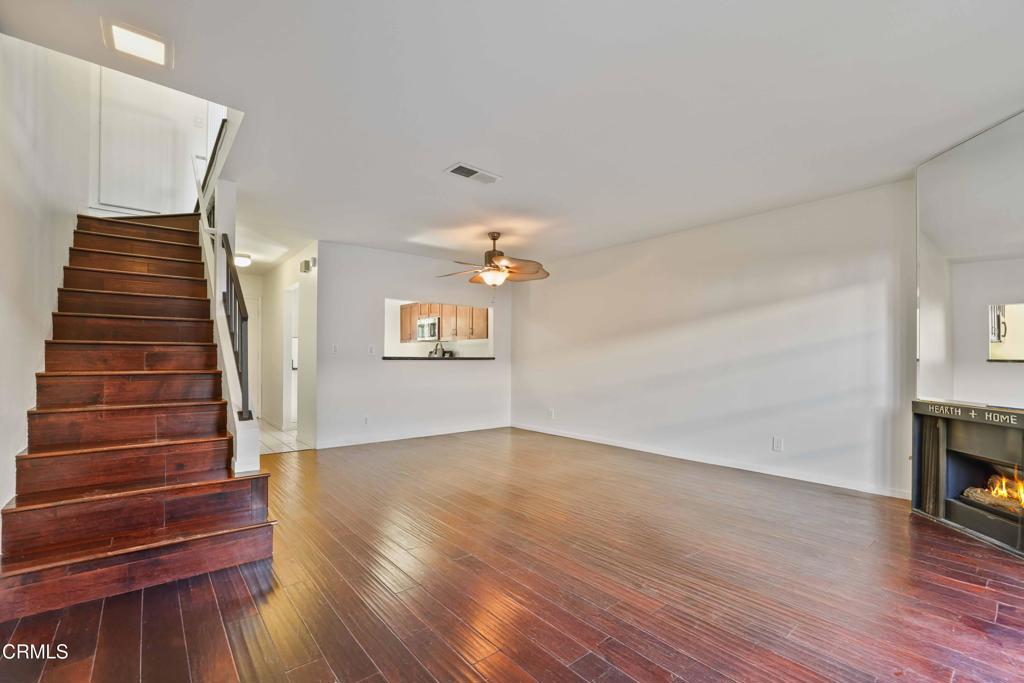 3183 Kelp Lane Oxnard, CA 93035 - Photo 11 of 23 a view of an empty room with wooden floor fireplace and a window
