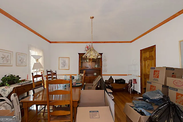 a living room with furniture chandelier and a large window
