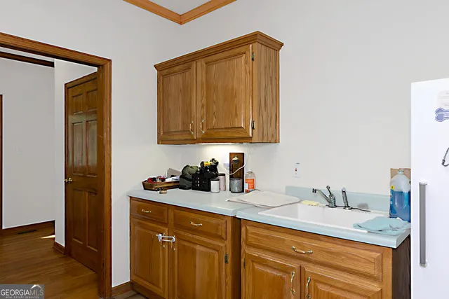 a bedroom with a bed a ceiling fan and a dresser