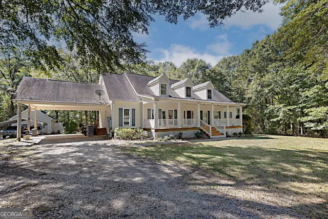 a view of backyard with deck and car parked