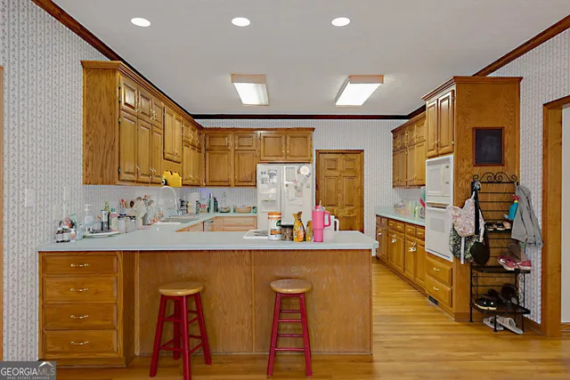 a kitchen with stainless steel appliances granite countertop a refrigerator and cabinets