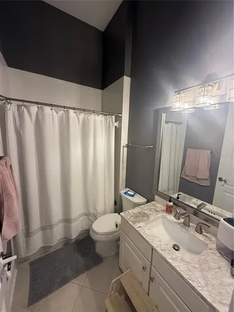 a bedroom with a bed dresser and a window