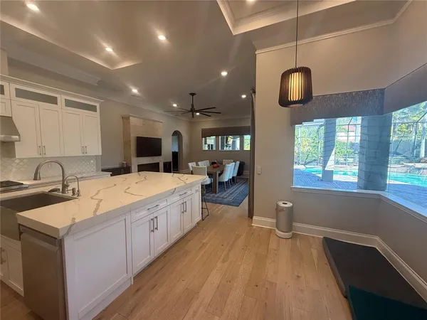 a large kitchen with stainless steel appliances lots of counter space and a sink