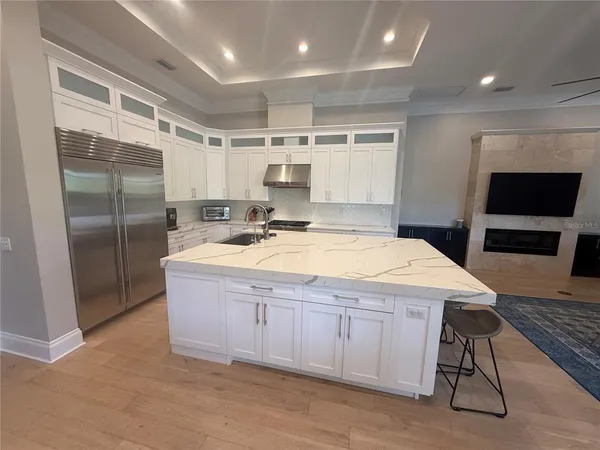 a bathroom with a sink a large mirror and a glass door shower