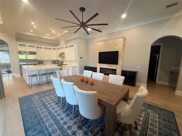 a living room with furniture large window and a fireplace