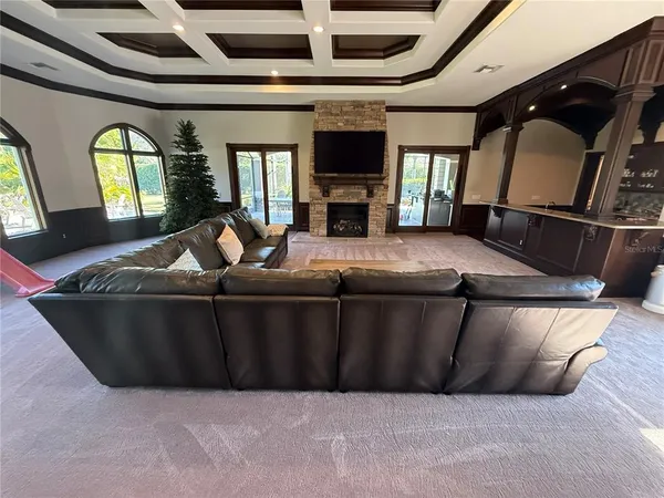 a bed sitting in a living room with a couch