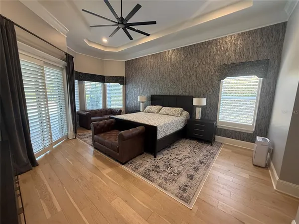 a bedroom with a bed and a flat screen television
