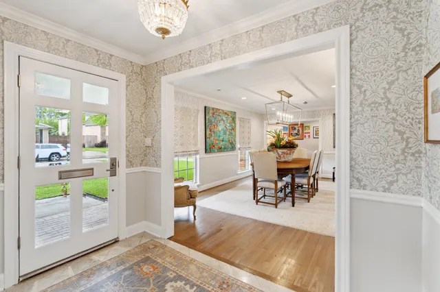 a dining room with furniture and a floor to ceiling window