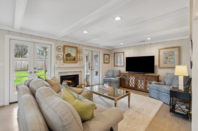 a living room with furniture a flat screen tv and a fireplace