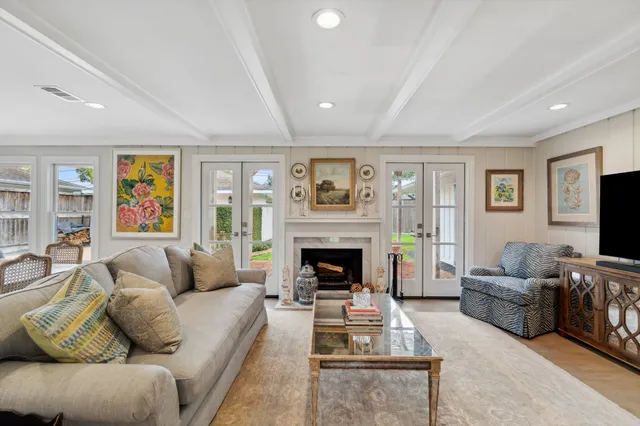 a living room with furniture flat screen tv and a fireplace
