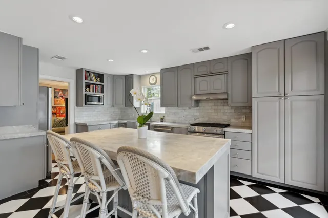 a kitchen with a sink a stove a refrigerator and cabinets