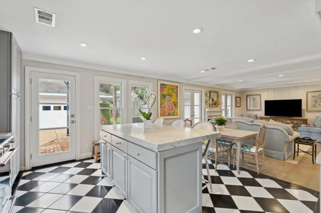 a kitchen with granite countertop cabinets a dining table and chairs