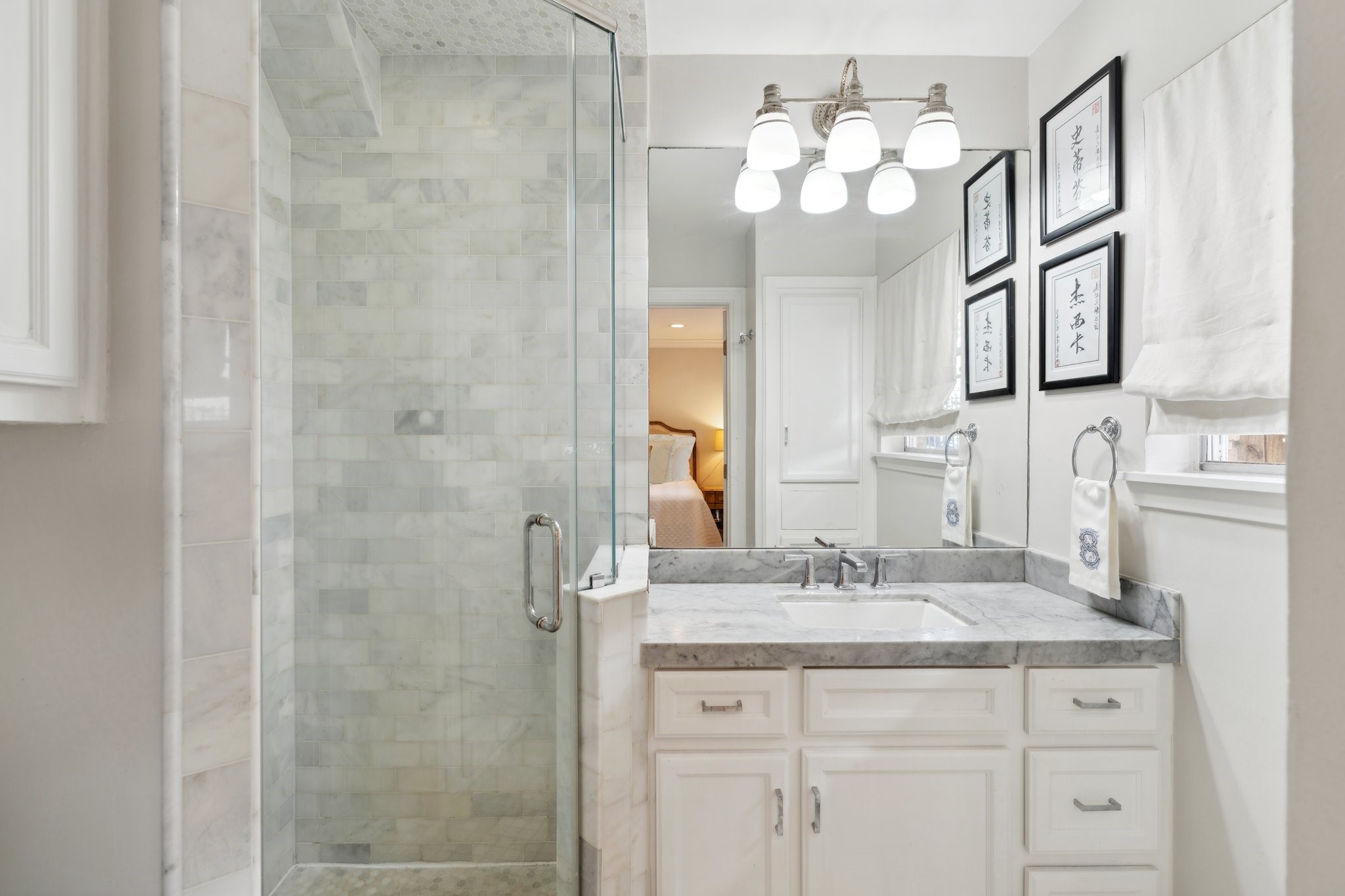 6158 Burgoyne Road Houston, TX 77057 - Photo 27 of 37 a bathroom with a granite countertop sink a large mirror and a shower