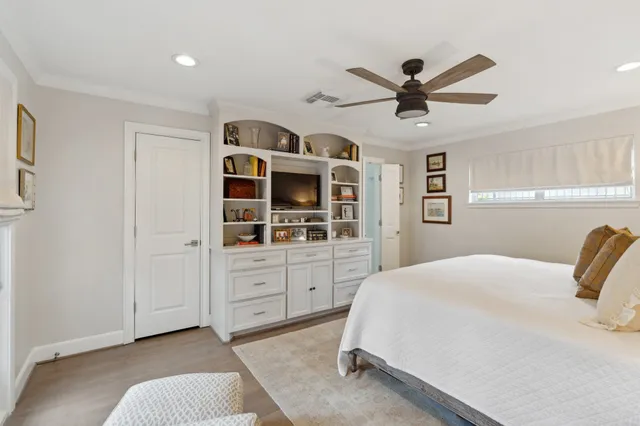 a view of a workspace with furniture and a book shelf