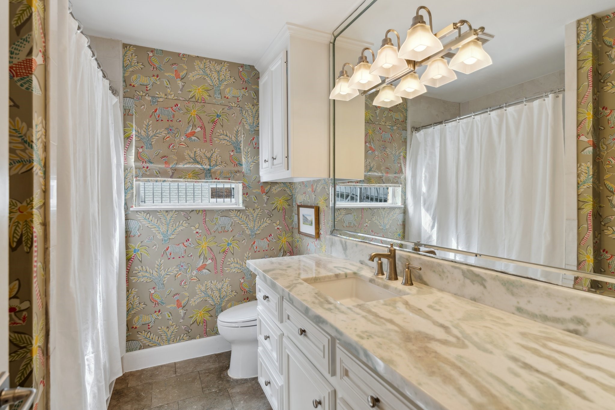6158 Burgoyne Road Houston, TX 77057 - Photo 33 of 37 a bathroom with a granite countertop sink a large mirror and a shower