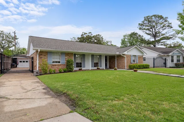 a front view of house with yard and green space