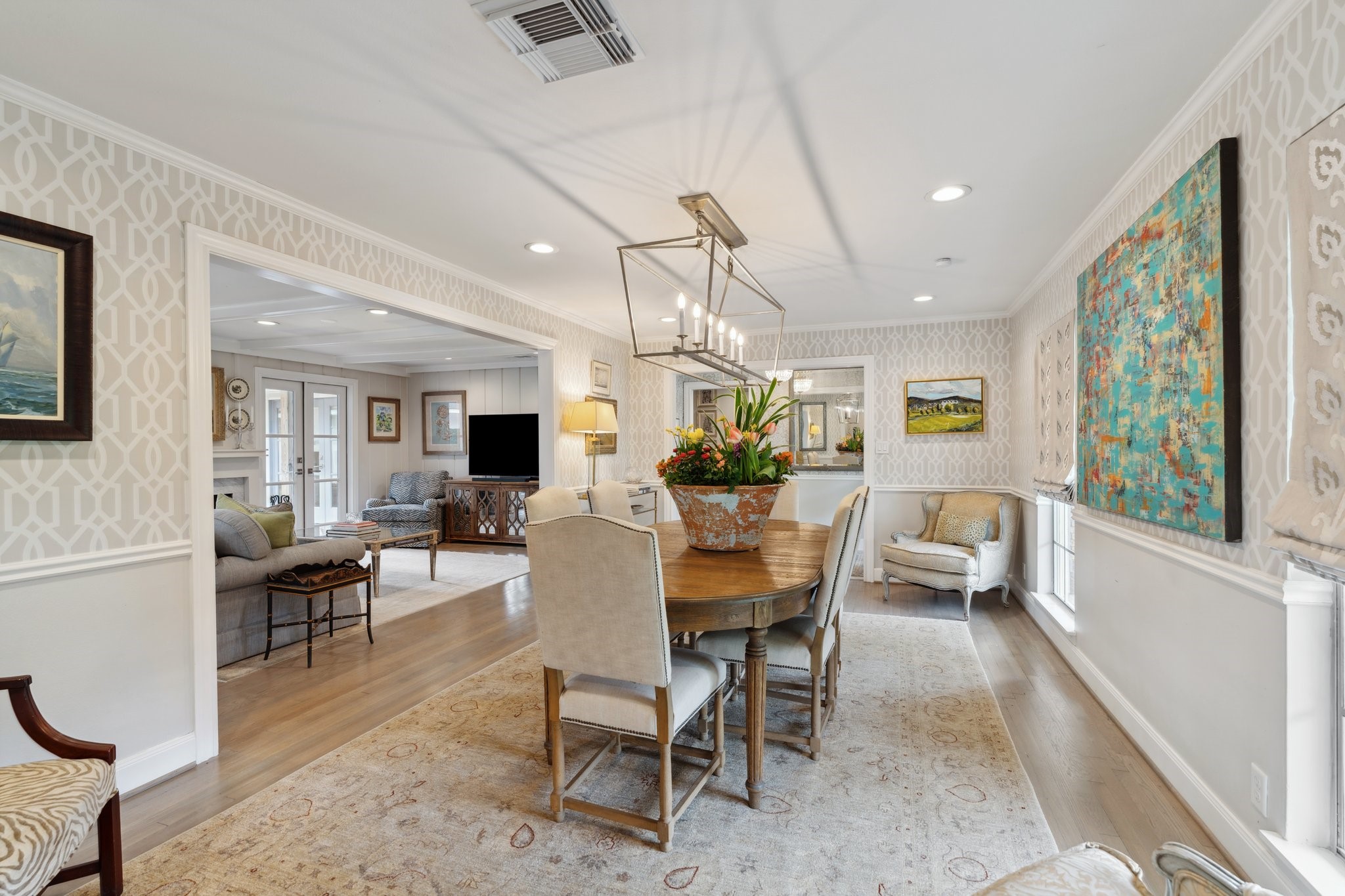 6158 Burgoyne Road Houston, TX 77057 - Photo 9 of 37 a dining room with wooden floor a chandelier a wooden table and chairs
