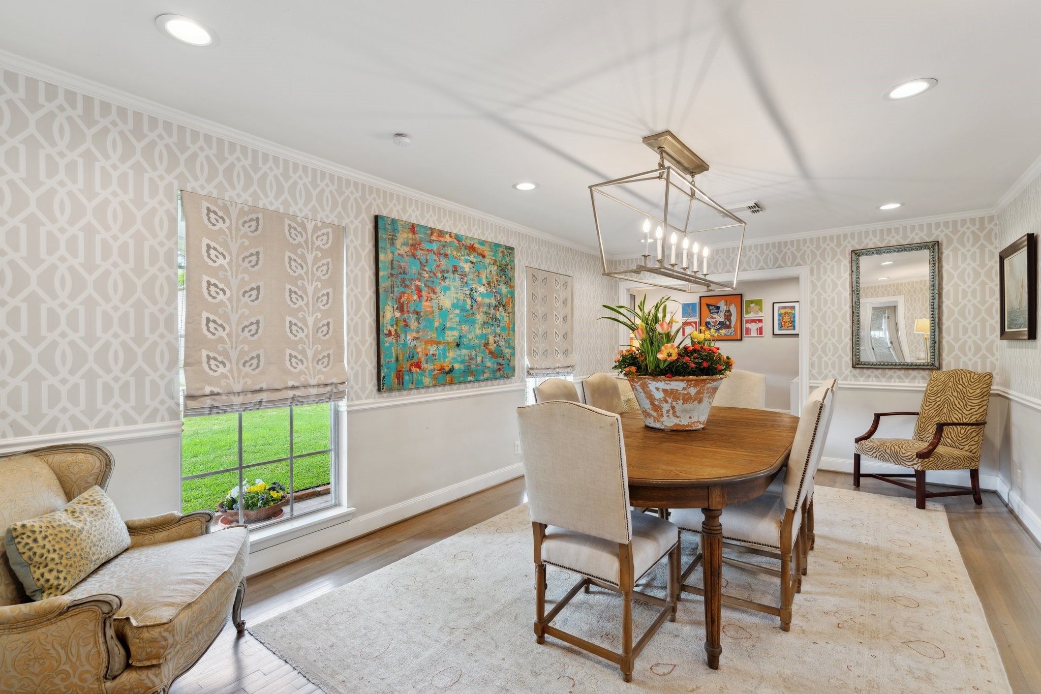 6158 Burgoyne Road Houston, TX 77057 - Photo 10 of 37 a dining room with furniture a chandelier and wooden floor