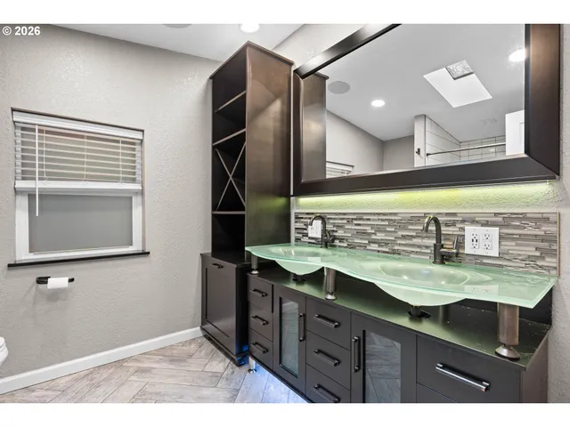 a bathroom with a sink and a mirror