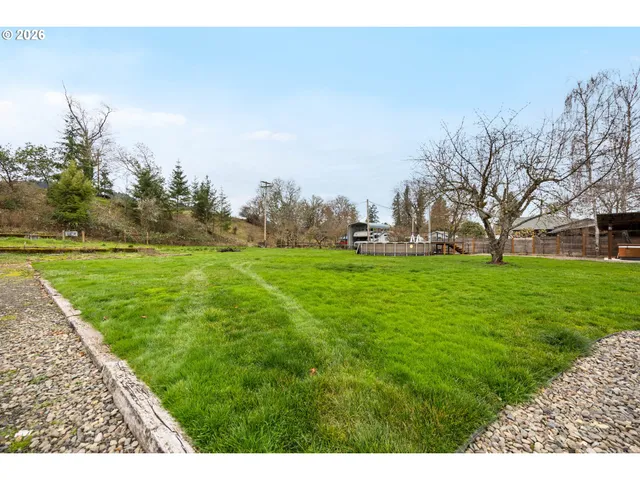 a view of grassy field with benches