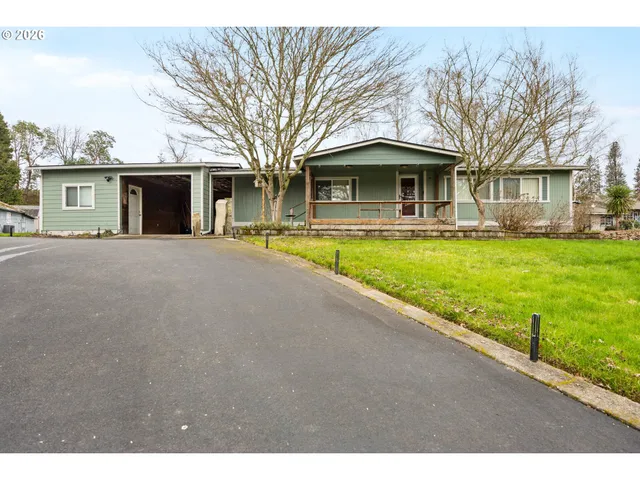 a front view of house with yard and trees