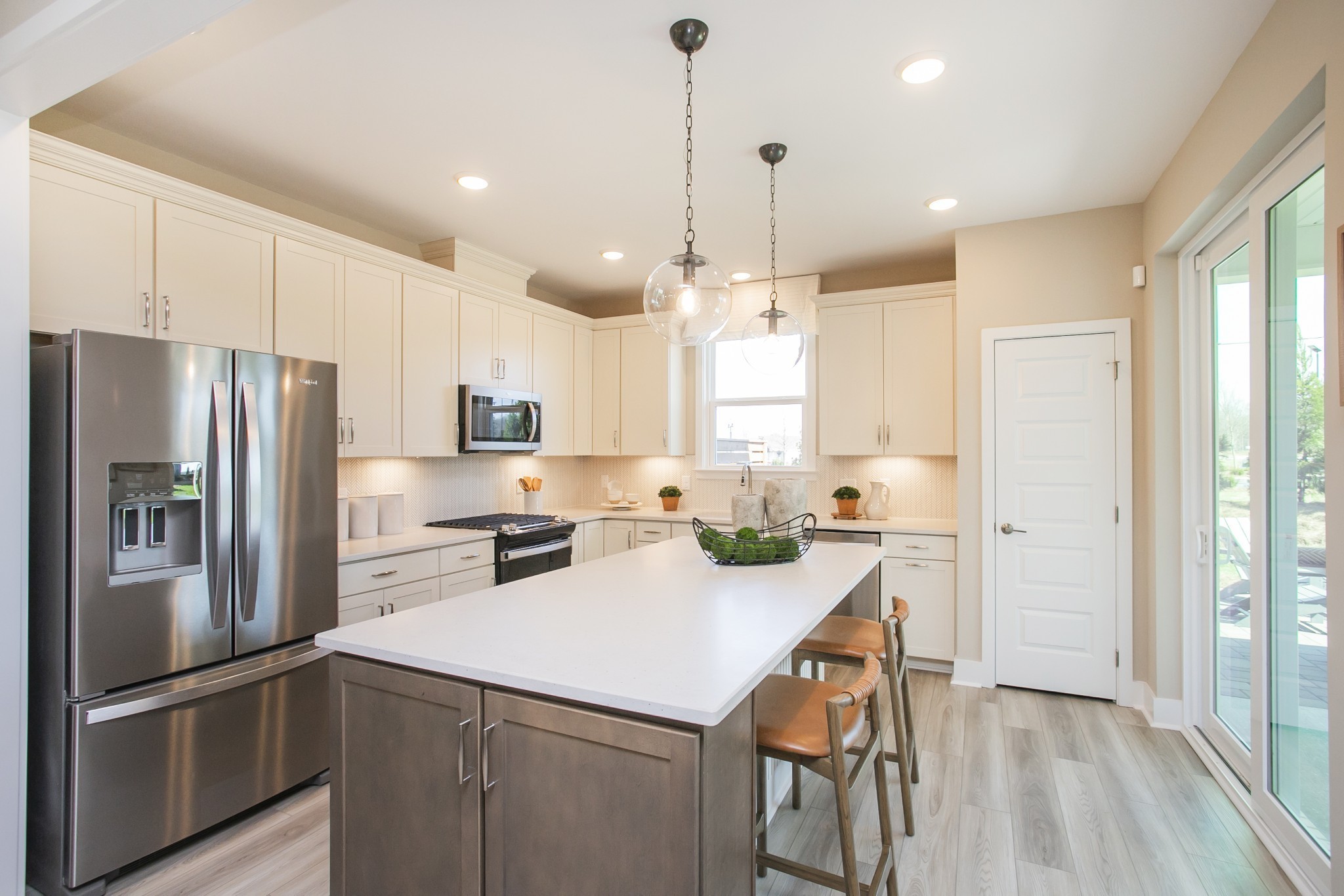 509 Scarlet Oak Road Lebanon, TN 37090 - Photo 25 of 32 a kitchen with refrigerator a sink and white cabinets