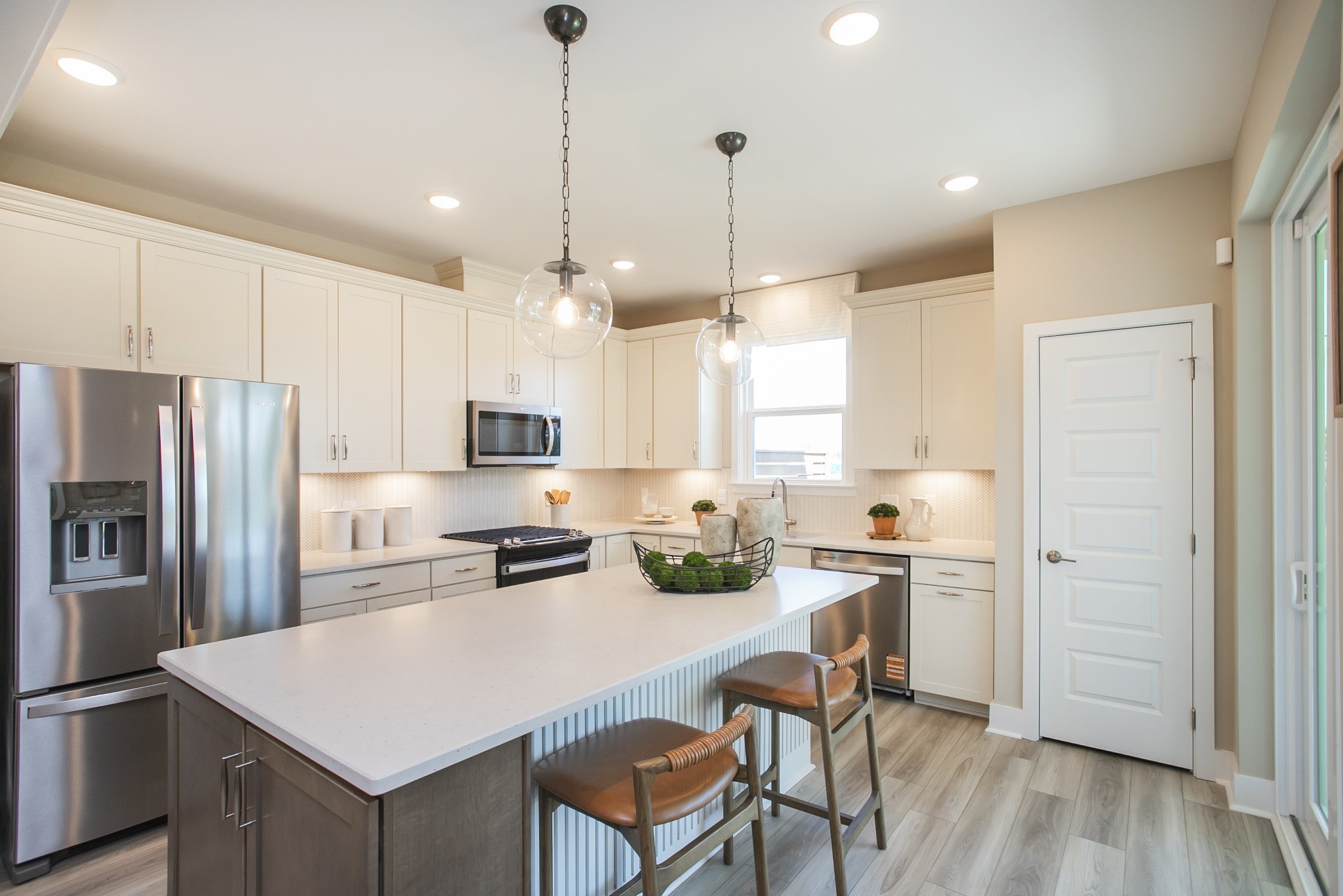509 Scarlet Oak Road Lebanon, TN 37090 - Photo 26 of 32 a kitchen with a refrigerator a stove a sink and white cabinets with wooden floor
