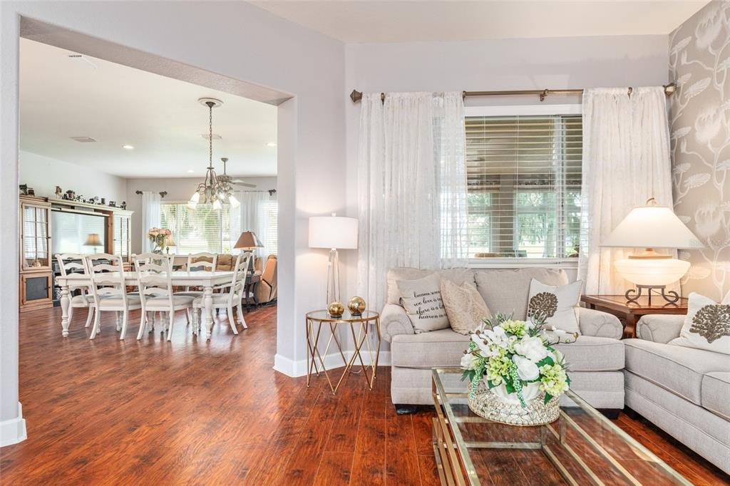 12895 Southeast 91st Terrace Road Summerfield, FL 34491 - Photo 13 of 99 a living room with furniture and wooden floor