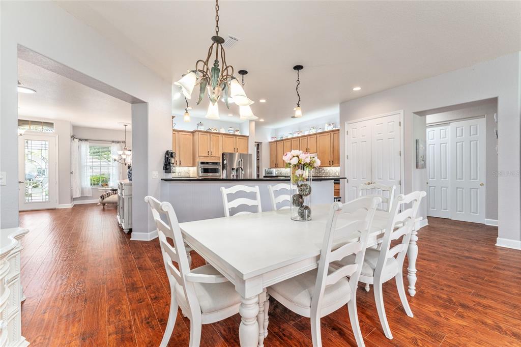 12895 Southeast 91st Terrace Road Summerfield, FL 34491 - Photo 25 of 99 a view of a dining room and livingroom with furniture wooden floor a chandelier