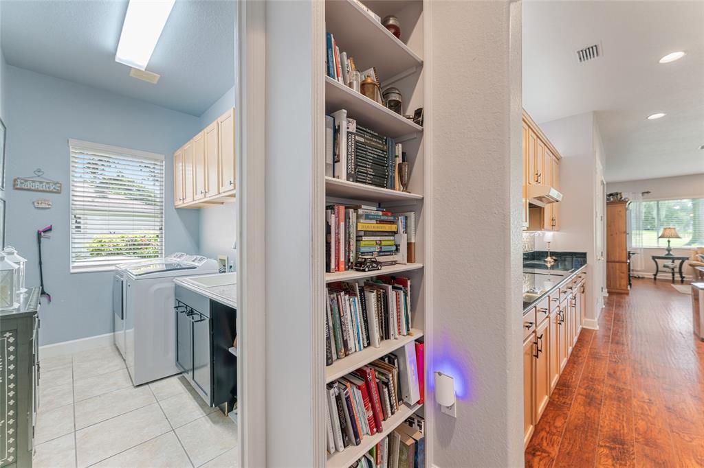 12895 Southeast 91st Terrace Road Summerfield, FL 34491 - Photo 63 of 99 a room with furniture cabinets and a book shelf