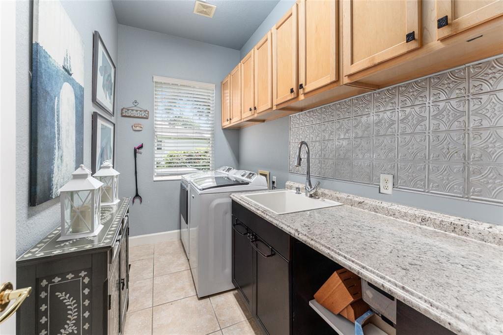 12895 Southeast 91st Terrace Road Summerfield, FL 34491 - Photo 64 of 99 a kitchen with granite countertop a sink a stove and cabinets