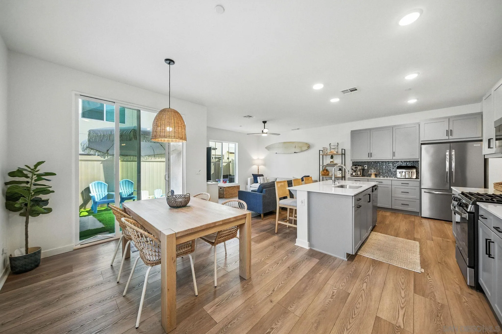 a kitchen with a table chairs refrigerator and microwave