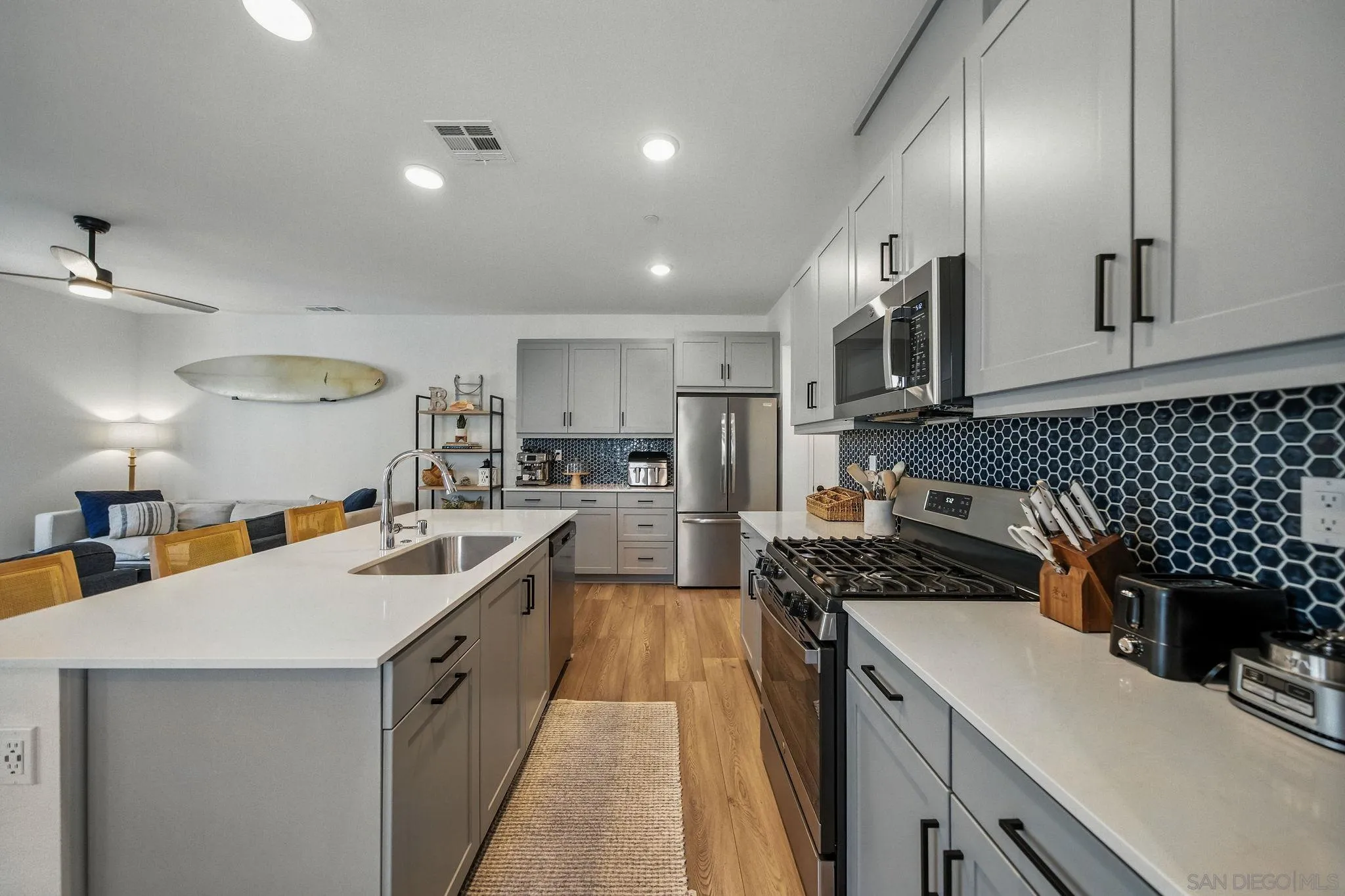 239 Blended Place Fallbrook, CA 92028 - Photo 12 of 64 a kitchen with a sink stove and cabinets
