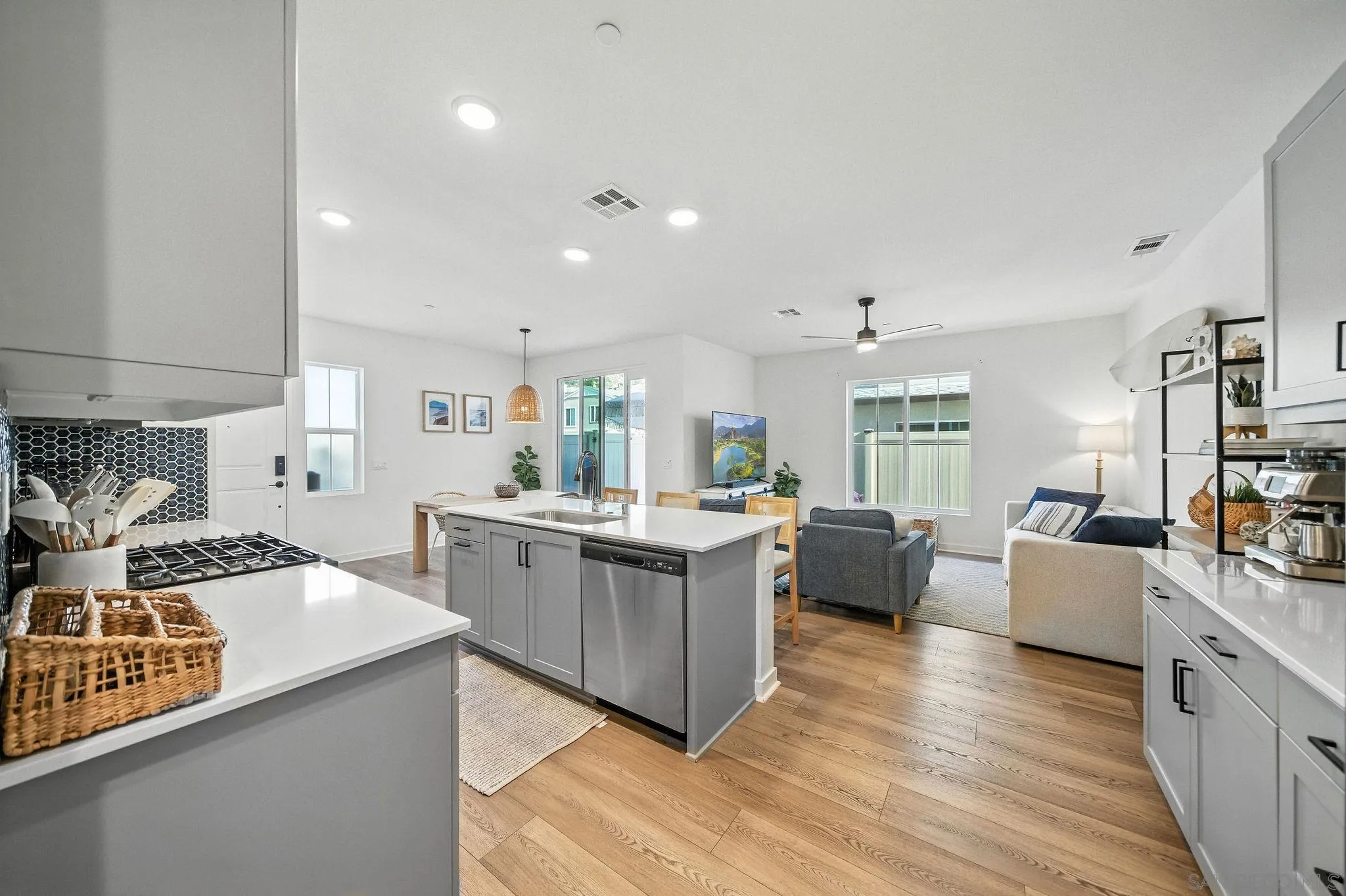 239 Blended Place Fallbrook, CA 92028 - Photo 17 of 64 a large kitchen with a table chairs wooden floor and stainless steel appliances