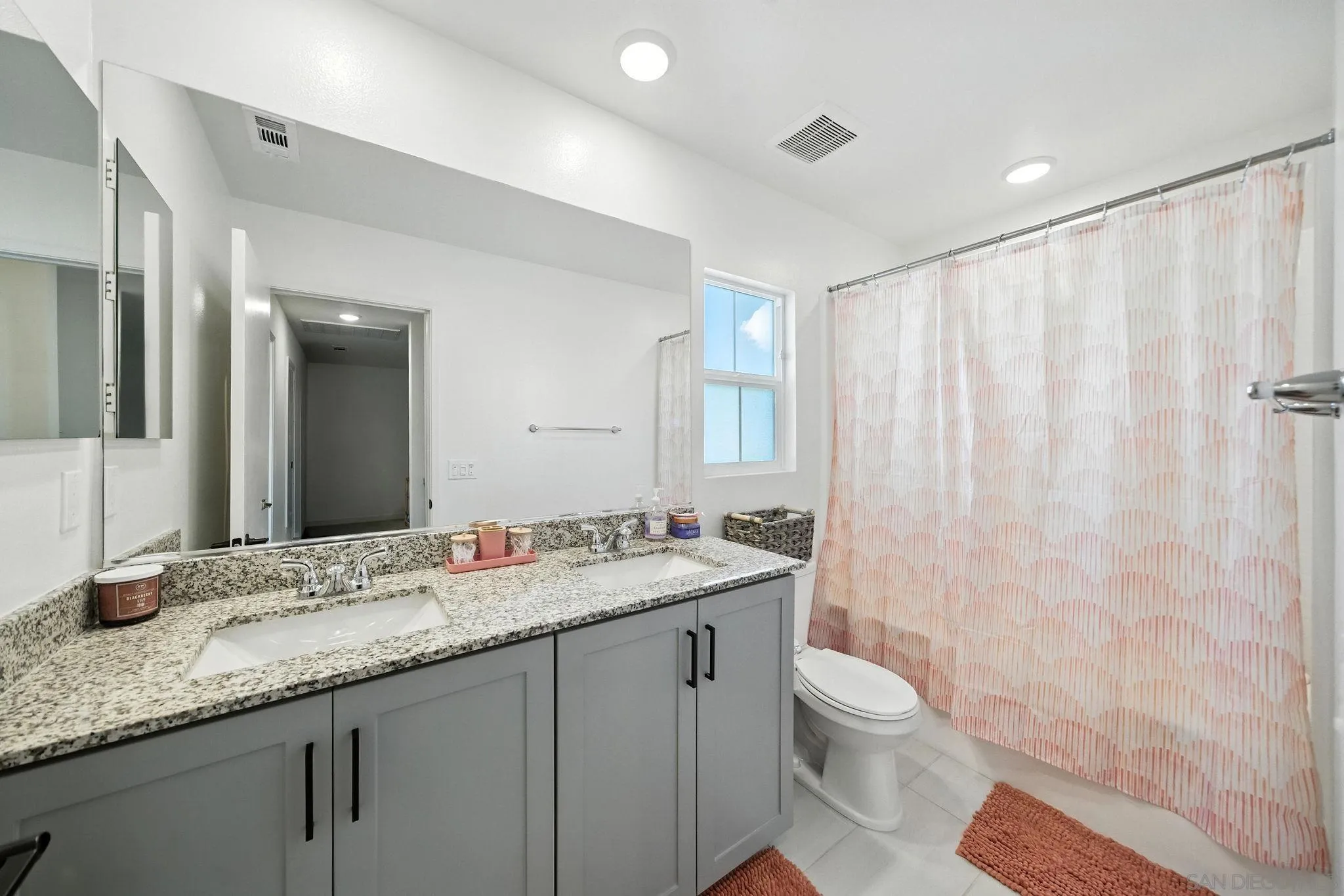 239 Blended Place Fallbrook, CA 92028 - Photo 32 of 64 a bathroom with a granite countertop sink a toilet and a mirror