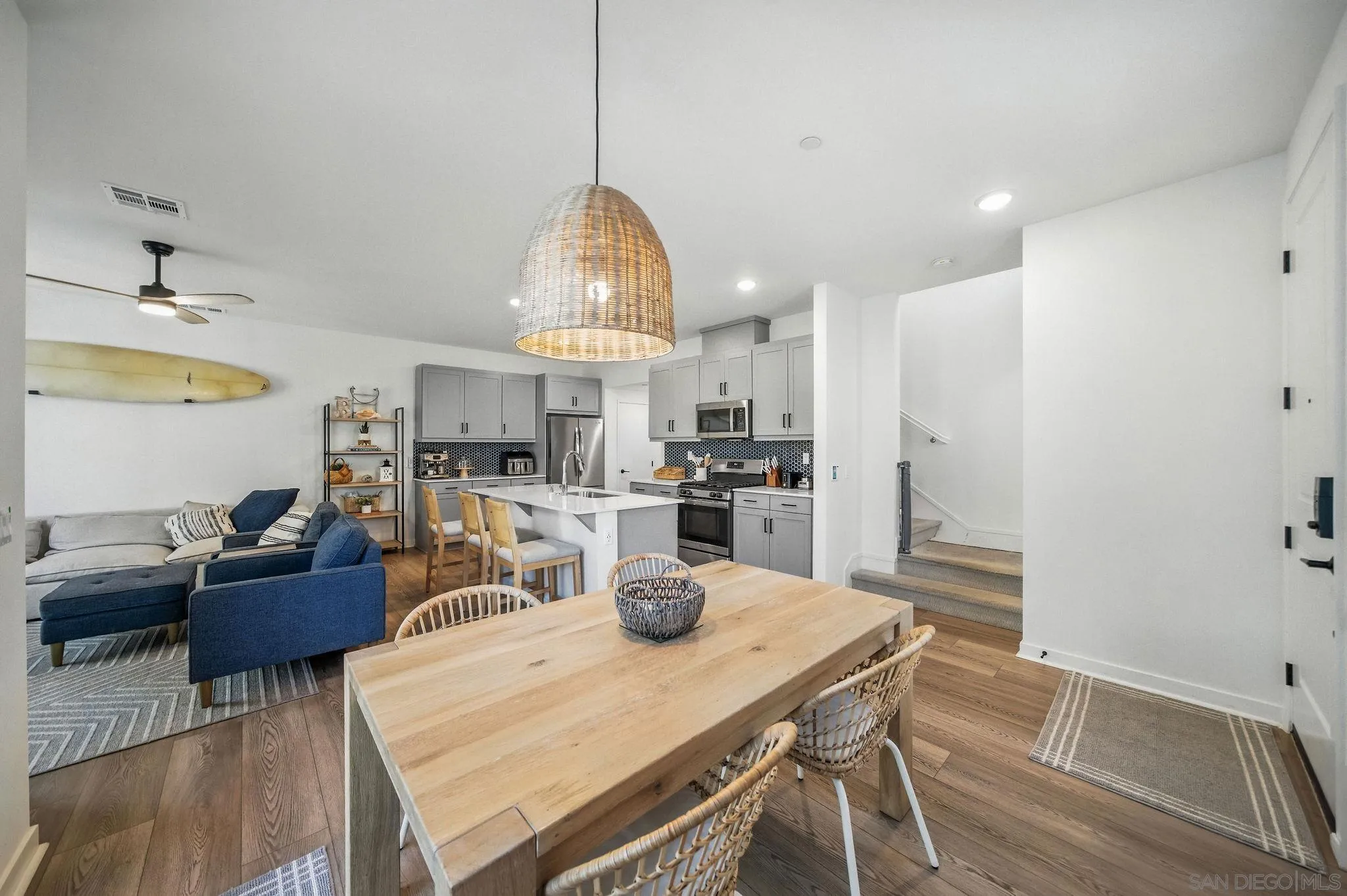 239 Blended Place Fallbrook, CA 92028 - Photo 6 of 64 a kitchen with kitchen island a stove a refrigerator a sink dishwasher a dining table and chairs with wooden floor