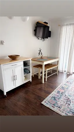 a view of a livingroom with furniture and wooden floor