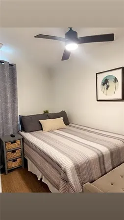 a bedroom with a bed and a painting on the wall