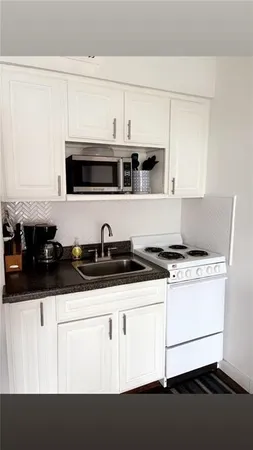 a kitchen with stainless steel appliances a sink and cabinets