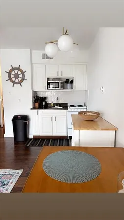a kitchen with a sink appliances and cabinets