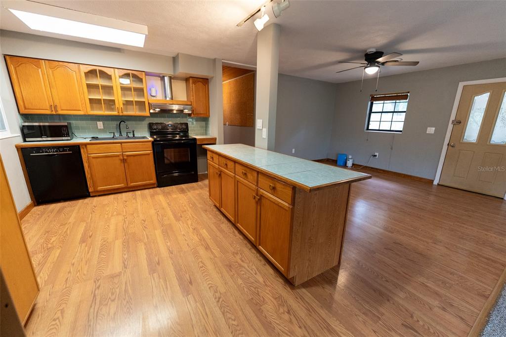 1860 Northeast 62nd Street Ocala, FL 34479 - Photo 11 of 64 a kitchen with stainless steel appliances granite countertop a stove a sink and a refrigerator