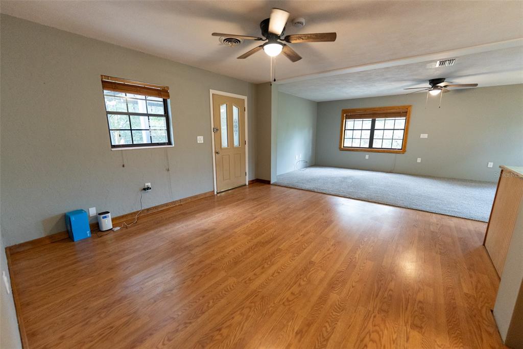 1860 Northeast 62nd Street Ocala, FL 34479 - Photo 17 of 64 a view of an empty room with a window and wooden floor