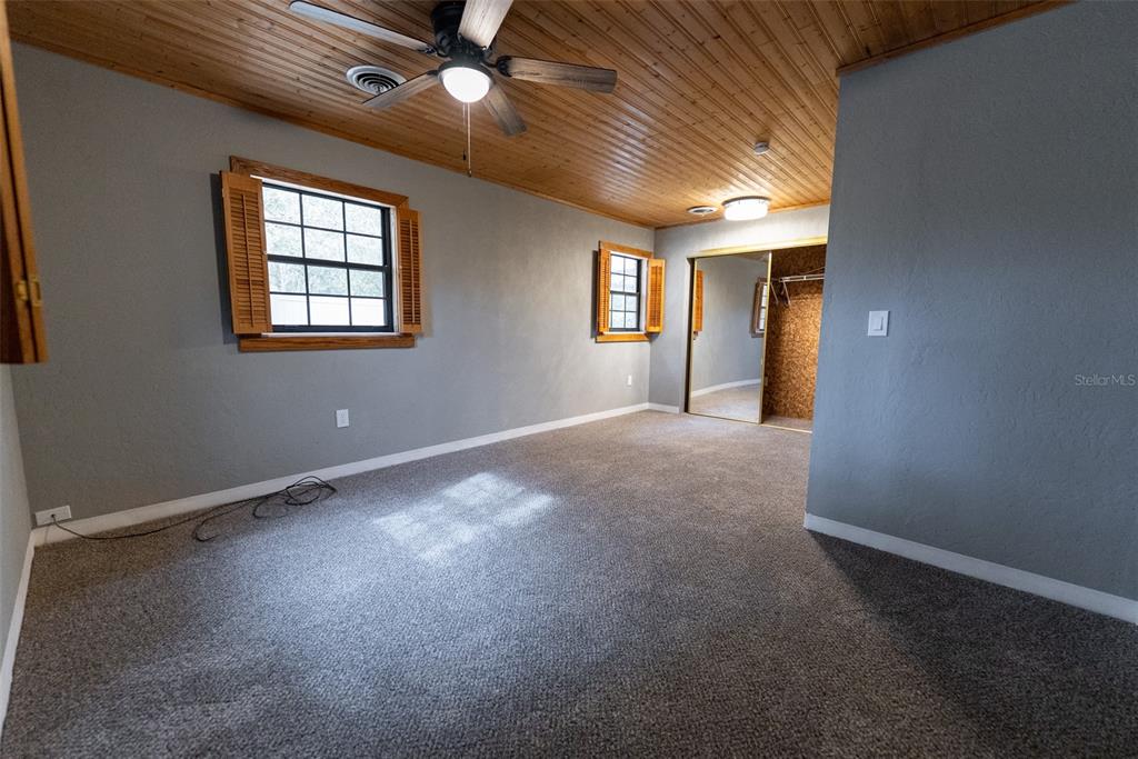1860 Northeast 62nd Street Ocala, FL 34479 - Photo 20 of 64 an empty room with windows and ceiling fan