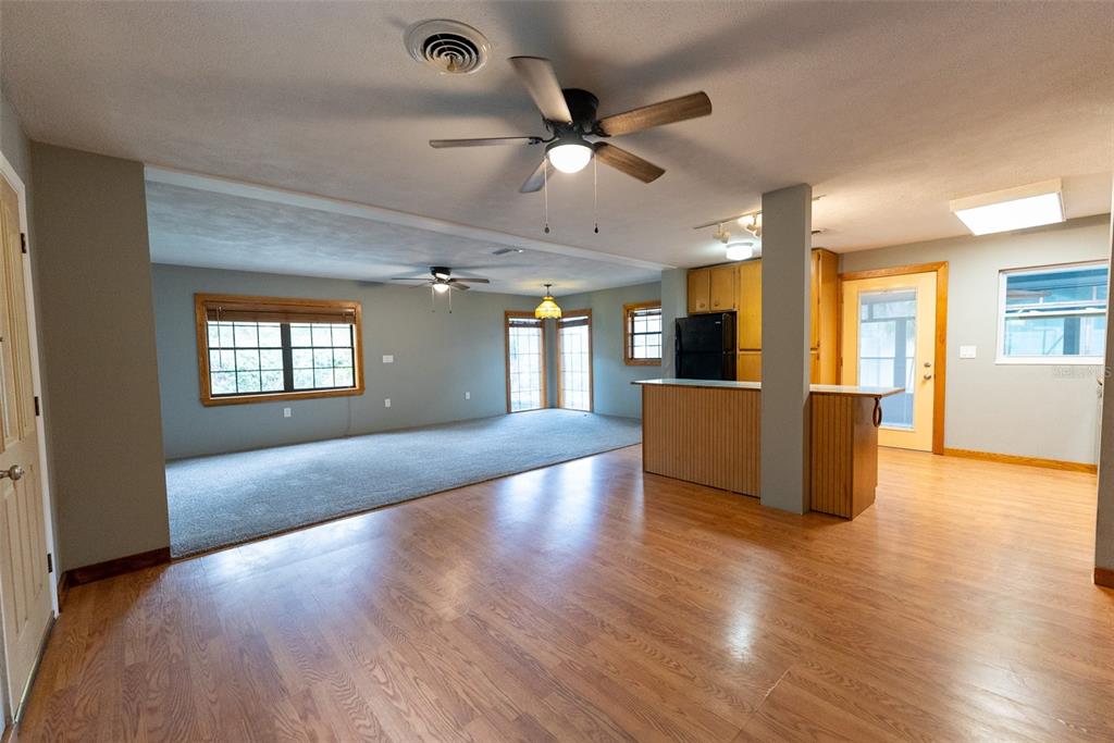 1860 Northeast 62nd Street Ocala, FL 34479 - Photo 2 of 64 a view of an empty room with wooden floor and a kitchen
