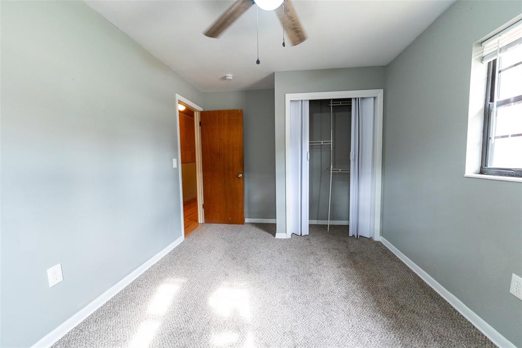 1860 Northeast 62nd Street Ocala, FL 34479 - Photo 25 of 64 an empty room with chandelier fan and windows