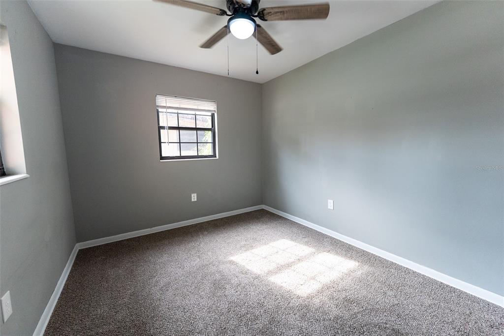 1860 Northeast 62nd Street Ocala, FL 34479 - Photo 27 of 64 an empty room with a window and a fan