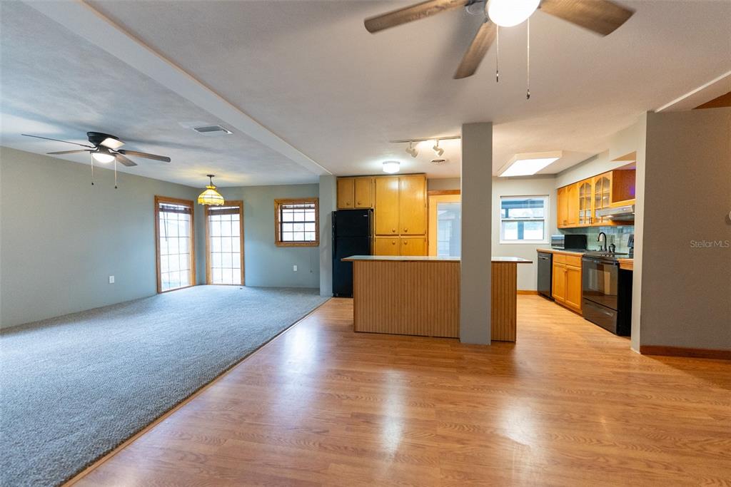 1860 Northeast 62nd Street Ocala, FL 34479 - Photo 3 of 64 a view of a kitchen with furniture and wooden floor