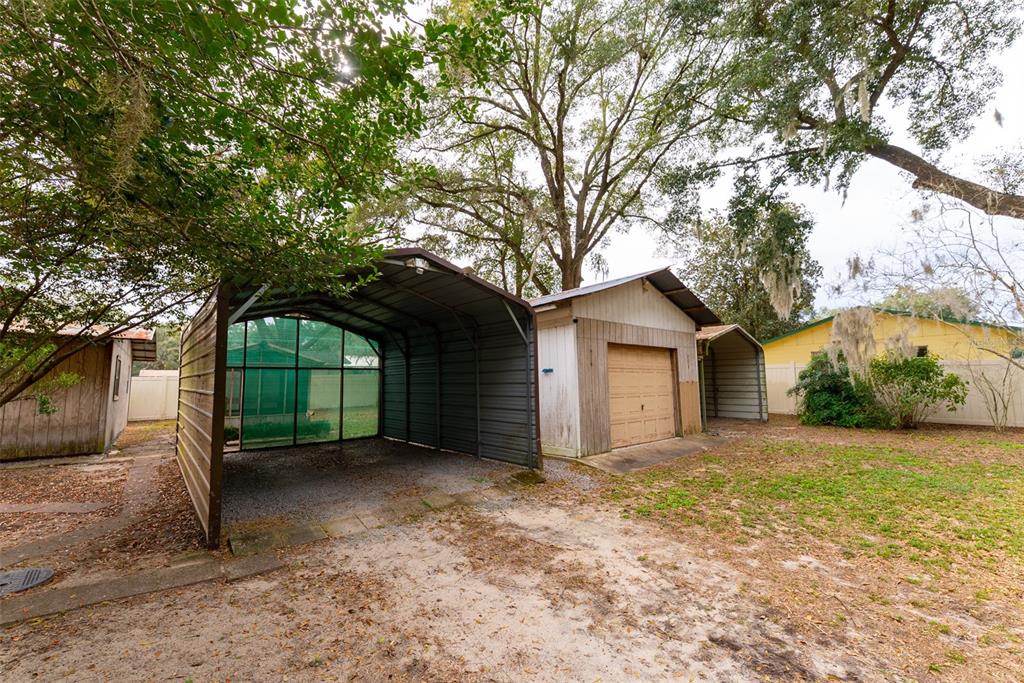 1860 Northeast 62nd Street Ocala, FL 34479 - Photo 43 of 64 a front view of a house with a yard and garage