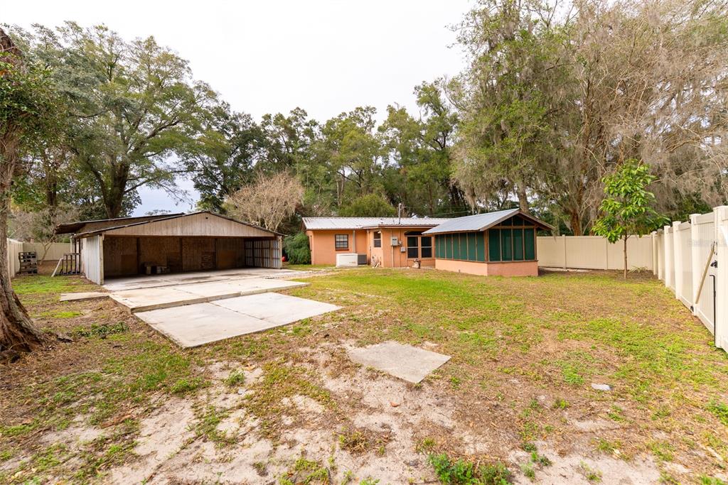 1860 Northeast 62nd Street Ocala, FL 34479 - Photo 50 of 64 a front view of a house with a yard