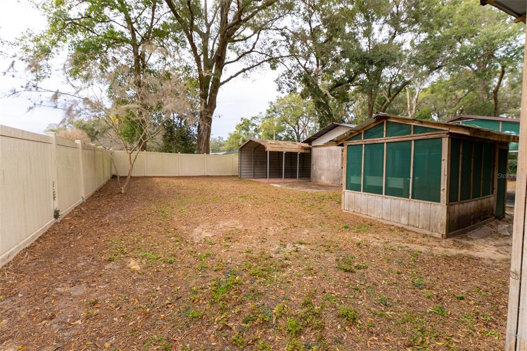 1860 Northeast 62nd Street Ocala, FL 34479 - Photo 56 of 64 a view of a house with a large tree and a yard